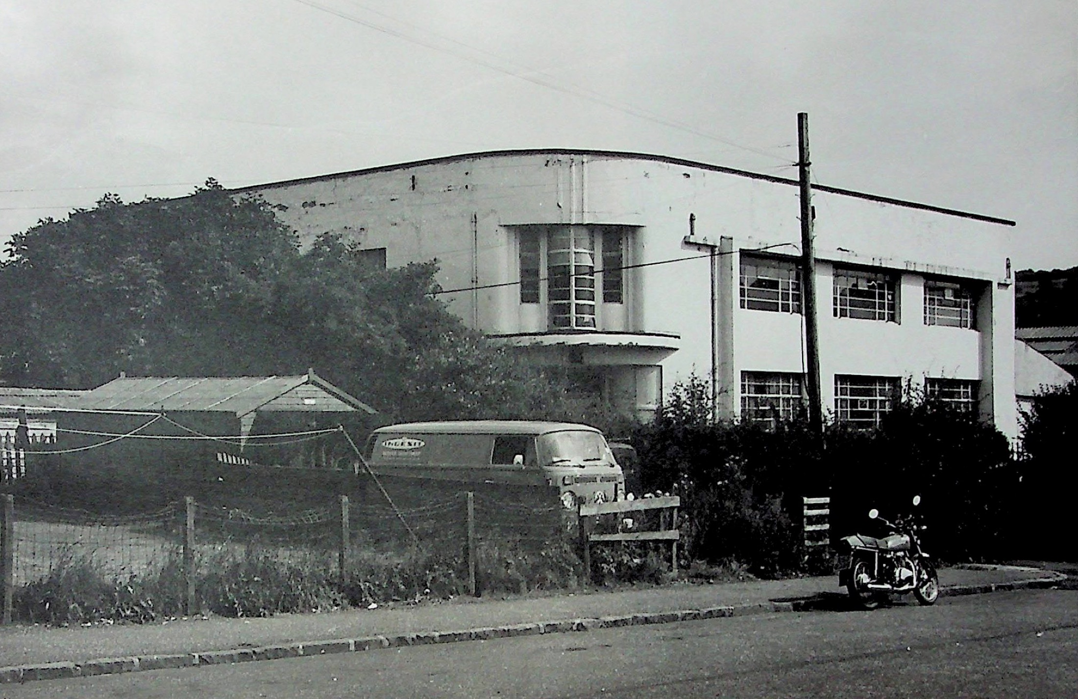 Curved white Art Deco office building at a Darvel factory