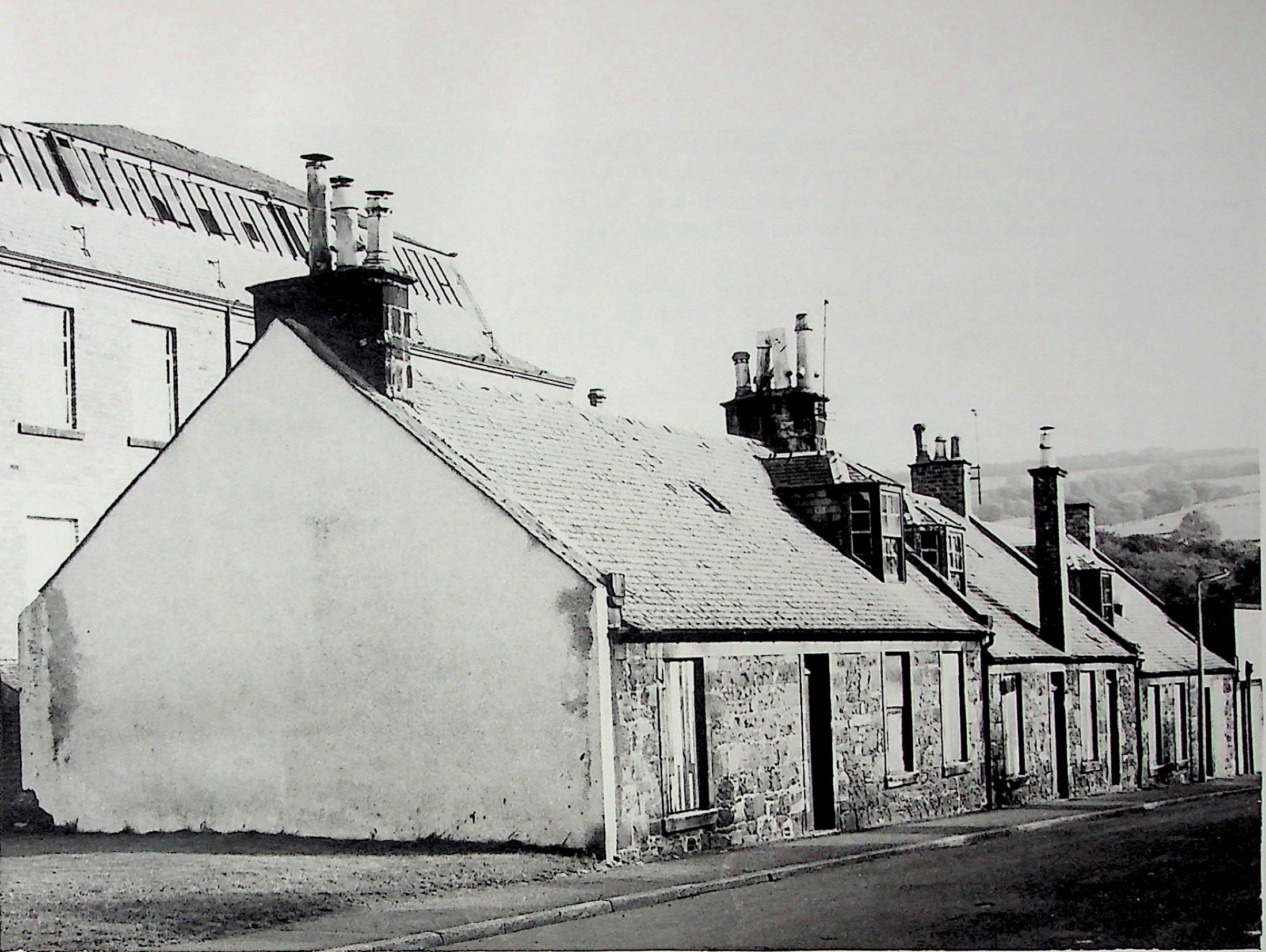 Stone loom-shop cottages with unusually tall windows