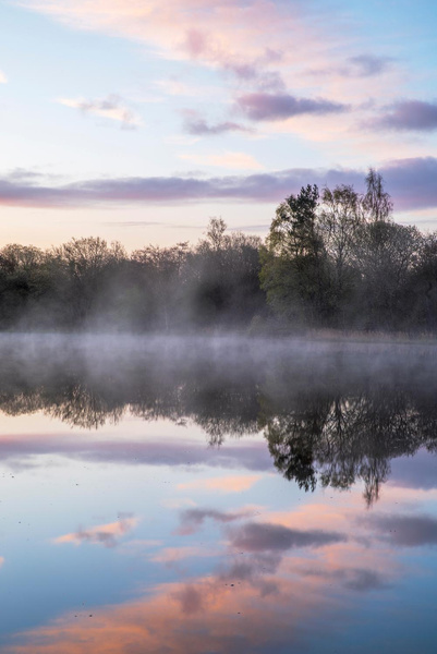 Mist rising from still water at dawn, photographed by Hugh Maxwell