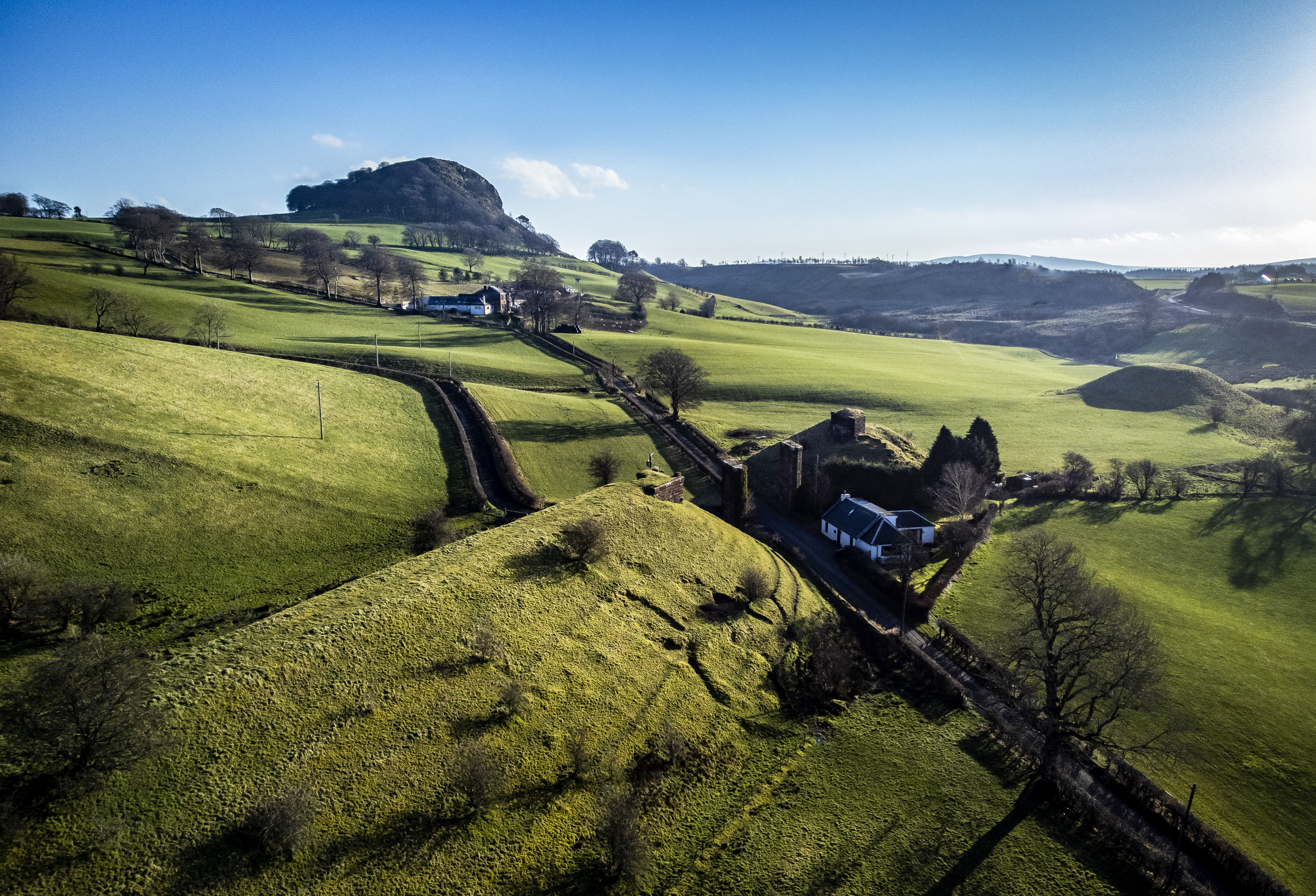 Loudoun Hill rising above the green farmland of the Irvine Valley