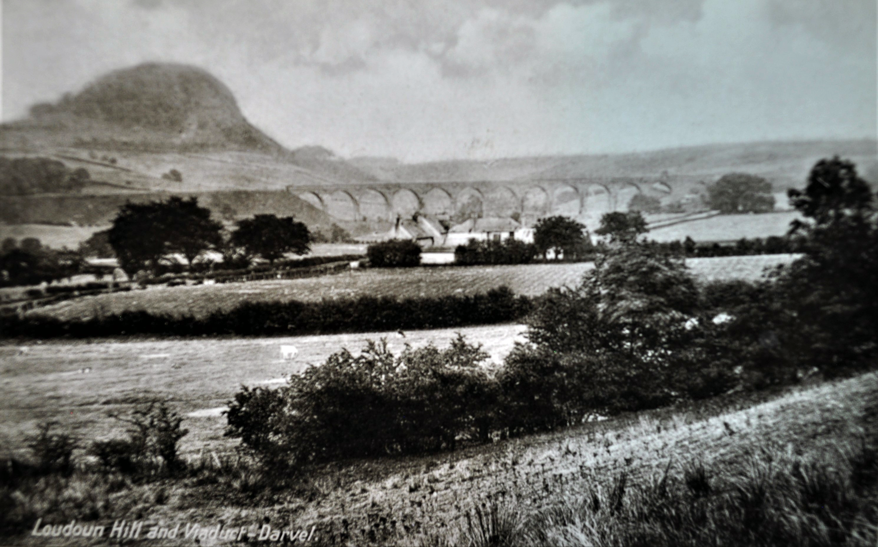 Historic view of Loudoun Hill, farmland and the former railway viaduct