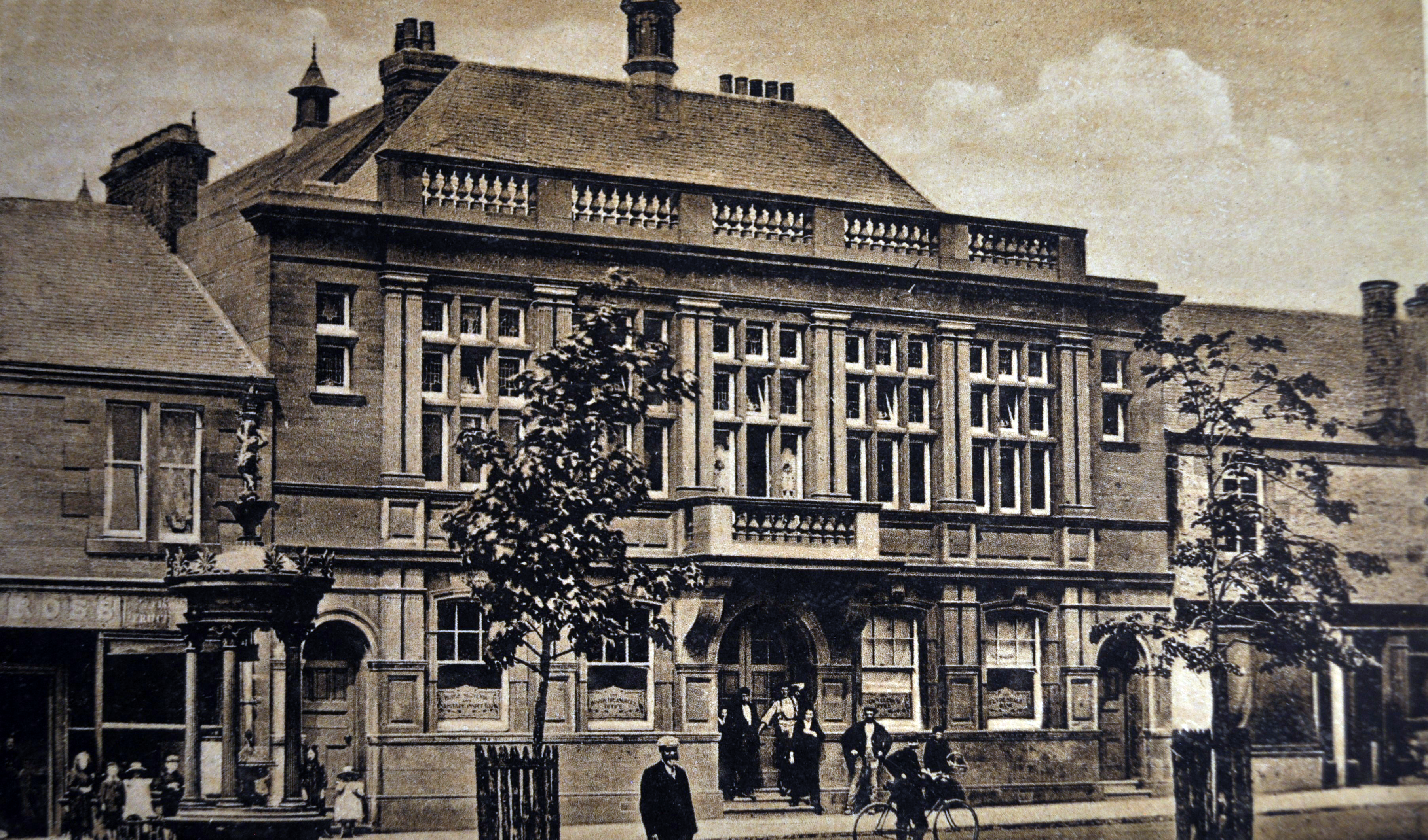 Historic view of Darvel Town Hall beside the town monument